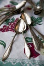 Vintage silver spoons on an antique tablecloth Royalty Free Stock Photo