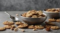 Vintage silver spoons with brown cookies of walnuts shape on grey concrete background