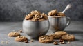 Vintage silver spoons with brown cookies of walnuts shape on grey concrete background