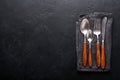 Vintage silverware. Rustic vintage set of wooden spoon and fork on black background. Top view. Mock up Royalty Free Stock Photo