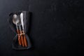 Vintage silverware. Rustic vintage set of wooden spoon and fork on black background. Top view. Mock up Royalty Free Stock Photo