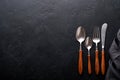 Vintage silverware. Rustic vintage set of wooden spoon and fork on black background. Top view. Mock up Royalty Free Stock Photo