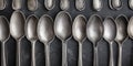 Vintage silverware spoons, arranged in a row, metallic texture, shiny utensils, kitchen decor concept Royalty Free Stock Photo