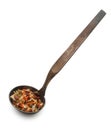 Vintage silverware, Very old dark rusted ladle, scoop with spices, dried herbs, isolated on a white, close up Royalty Free Stock Photo