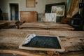 Vintage slake chalkboard on old school-desk with rabbit leg used to erase the writing