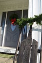 Vintage sled and Christmas decorations on house