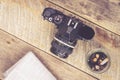 Vintage SLR camera ashtray newspaper on wooden table Royalty Free Stock Photo