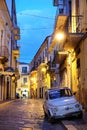 Vintage small Fiat 500 car parked in old town of Foggia at night. Puglia, Italy Royalty Free Stock Photo