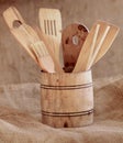 Vintage small wooden bucket with various kitchen utensils