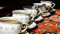 Vintage soviet porcelain cups of tea with saucers on turkish carpet, traditional tea ceremony, sunlight Royalty Free Stock Photo