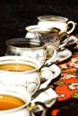 Vintage soviet porcelain cups of tea with saucers on turkish carpet, traditional tea ceremony, sunlight Royalty Free Stock Photo