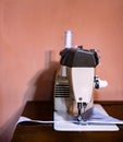 Old sewing machine situated on a wooden table in a home interior Royalty Free Stock Photo