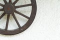 Vintage spinning wheel on the white wall background