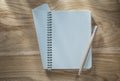 Vintage spiral notebook pencil on wooden board Royalty Free Stock Photo