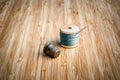 Vintage spool of thread with needle and thimble closeup on old wooden background. Royalty Free Stock Photo