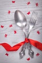 Vintage spoon and fork with a red tape, angels and butterflies for Valentine`s day on a wooden Royalty Free Stock Photo