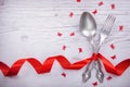 Vintage spoon and fork with a red tape, angels and butterflies for Valentine`s day on a wooden Royalty Free Stock Photo