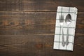 Vintage spoons and fork with napery on wooden background. Royalty Free Stock Photo