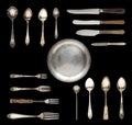 Vintage spoons, knives, forks and a plate isolated on a white background.