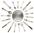 Vintage spoons, knives, forks and a plate lined isolated on white background