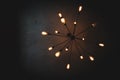 A vintage sputnik black decorative chandelier hanging from a dark ceiling in a room