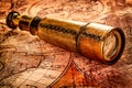 Vintage spyglass lies on an ancient world map Royalty Free Stock Photo