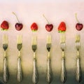 Vintage squared composition with silver forks strawberries annd cherries Royalty Free Stock Photo