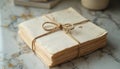Vintage stack of squared paper sheets tied with twine on marble surface. Aged, textured paper notes create retro, antique Royalty Free Stock Photo