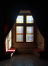 Vintage stained-glass window in old castle interior Royalty Free Stock Photo