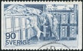 Vintage stamp printed in Sweden circa 1975 shows customs officer with a dog