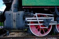 Vintage steam locomotive detail with cranks and red wheels Royalty Free Stock Photo