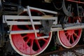 Vintage steam locomotive detail with cranks and red wheels Royalty Free Stock Photo