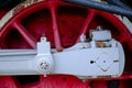 Vintage steam locomotive detail with cranks and red wheels Royalty Free Stock Photo