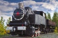 Vintage steam train on a background of autumn trees and blue sky Royalty Free Stock Photo