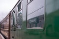 Vintage steam train on the platform at Swanage railway station. The `Swanage` sign is reflected in windows on side of train. Royalty Free Stock Photo