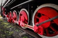 Vintage steam train with vibrant red metal wheels. Royalty Free Stock Photo
