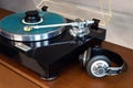 Vintage Stereo Turntable Record Player With Blue Colored Disk, Headphones and Black Weight Clamp Royalty Free Stock Photo