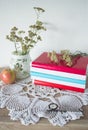 Vintage still life with books, watches, apple and vase with flowers on doily Royalty Free Stock Photo