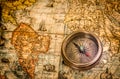 Vintage still life. Vintage compass lies on an ancient world map of 1565. Vintage style travel and adventure Royalty Free Stock Photo