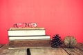 Vintage still life of stack of old books with glass and pine see Royalty Free Stock Photo