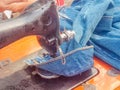 Vintage Stitching: Close-up of a Sewing Machine Mending Jeans with a Repair and Reuse Cloth Concept Background Royalty Free Stock Photo