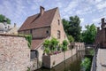 Vintage stone houses over canal and ancient medieval street picturesque landscape in summery sunny day with blue sky white clouds