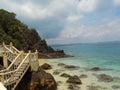 Vintage stone stairs on the edge of the rocks over the blue ocean, Malaysia