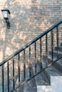 Vintage stone stairs metal black banister and brick wall exterior for home and living retro achitecture decoration. Antique house Royalty Free Stock Photo