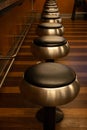 Vintage shiny vinyl stools in the restaurant. Row vintage stools in front of wooden counter inside a vintage style bar Royalty Free Stock Photo