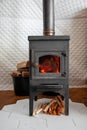 A vintage stove is heated with wood, heats a country house Royalty Free Stock Photo