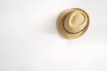 Vintage Straw hat hanging on white wall