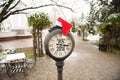 Vintage street clock with title Happy New Year 2018 and Santa Claus hat on them in winter city park Royalty Free Stock Photo