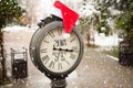 Vintage street clock with title Happy New Year 2018 and Santa Claus hat on them with falling snowflakes Royalty Free Stock Photo