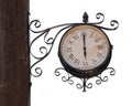 Vintage street clock on a wooden pole isolated on white Royalty Free Stock Photo